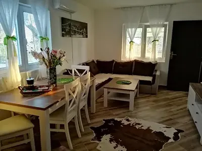 a living room with a table and a couch at Apartman Nikocevic in Dobra Voda