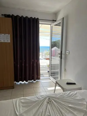 a bedroom with a bed and a view of the ocean at Apartments Feniks in Ulcinj