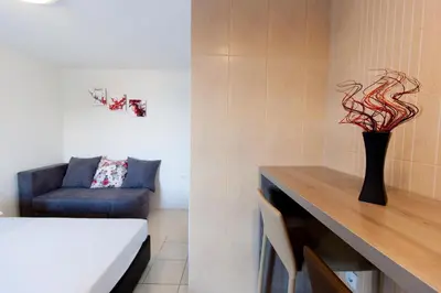 a room with a couch and a vase with a plant at Apartments Feniks in Ulcinj