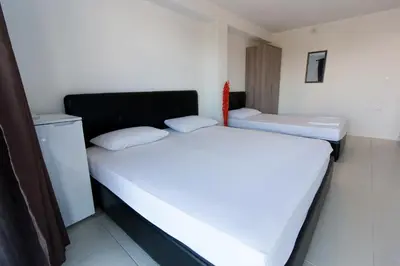 two beds in a small room with at Apartments Feniks in Ulcinj