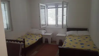 a small room with two beds and a window at Room 4 U in Bar