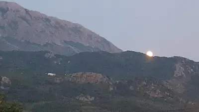 a sun setting on top of a mountain at Room 4 U in Bar