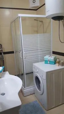 a bathroom with a washing machine and a sink at Green Silence - Vuk in Podgorica