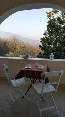 a table and two chairs on a balcony with a view at Green Silence - Vuk in Podgorica