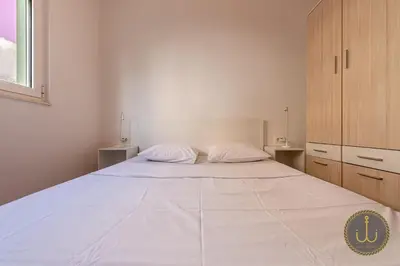 a large white bed in a white bedroom at Ancora 1 in Budva