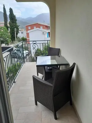 a balcony with a table and chairs on a balcony at Apartments Aleksić in Bar