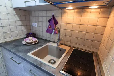 a kitchen with a sink and a counter top at Apartments Aleksić in Bar