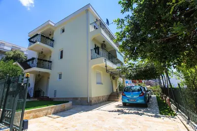 a car parked in front of a building at Apartments Aleksić in Bar