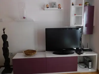 a tv sitting on top of a white cabinet at Apartments Svilen Konac in Budva