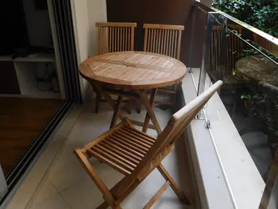 a wooden table and two chairs on a balcony at Apartments Svilen Konac in Budva