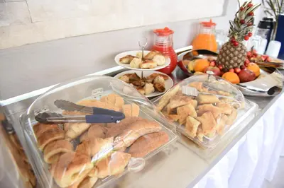 a counter with a bunch of different types of food at Apartments Cota Guesthouse in Ulcinj