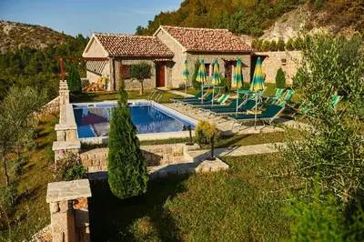 a house with a swimming pool in a yard at Eco Resort Cermeniza in Virpazar