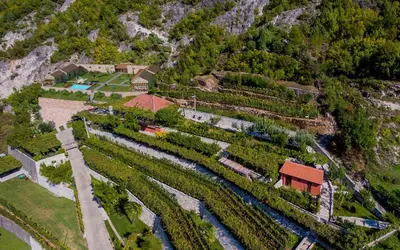 an aerial view of a farm with a river at Eco Resort Cermeniza in Virpazar