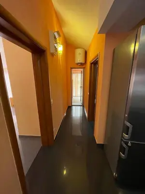 a hallway of an office with orange walls and a long hallway at Apartment Crocus of Rafailovici in Budva