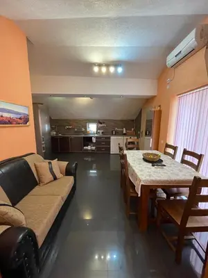 a living room with a couch and a table at Apartment Crocus of Rafailovici in Budva