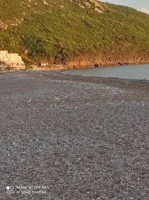 a large amount of rocks on the shore of a lake at Apartmani Grozdanic Canj in Čanj