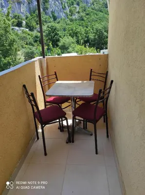 a table and chairs on a balcony with a view at Apartmani Grozdanic Canj in Čanj