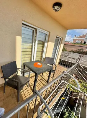a patio with a table and chairs on a balcony at Montenegrina Apartment in Budva