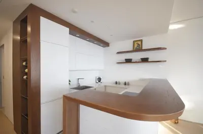 a kitchen with white cabinets and a wooden counter top at Duklej Apartment LUX in Budva