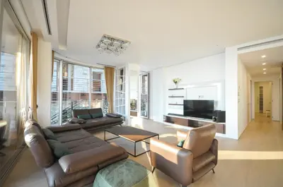 a living room with a couch and chairs and a television at Duklej Apartment LUX in Budva