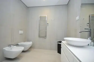 a bathroom with two white sinks and a toilet at Duklej Apartment LUX in Budva