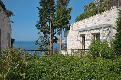 a stone house with a view of the ocean at Duklej Apartment LUX in Budva