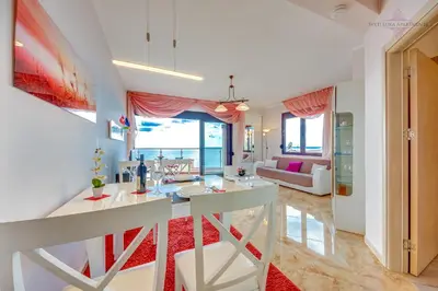 a living room with a table and a couch at Sveti Luka Apartments in Dobra Voda
