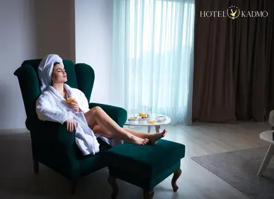 a woman sitting in a chair with a towel on her head at Hotel Kadmo by Aycon in Budva