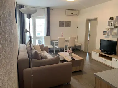 a living room with a couch and a table at Apartman Glava Zete in Sutomore