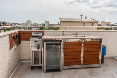 a kitchen on a balcony with a sink at Apartments Davor in Bar