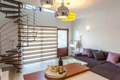a living room with a couch and a staircase at Apartments Davor in Bar