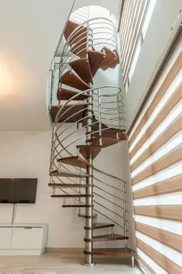 a metal spiral staircase in a room with a window at Apartments Davor in Bar