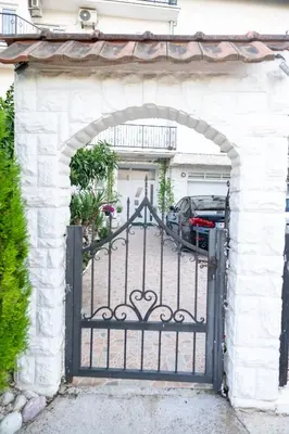 an entrance to a driveway with an iron gate at Guest House Aldin in Ulcinj