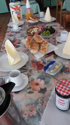 a table with plates of food and cups and plates of food at Guest House Aldin in Ulcinj