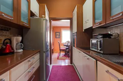 a kitchen with a refrigerator and a dining room at Apartments Varja in Sveti Stefan