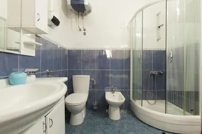 a bathroom with a sink and a toilet and a tub at Apartments Varja in Sveti Stefan