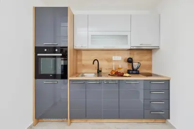 a kitchen with gray cabinets and a sink at Carpe Diem Apartments in Kotor