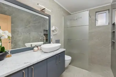 a bathroom with a sink and a toilet and a shower at Carpe Diem Apartments in Kotor