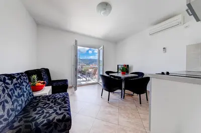 a living room with a couch and a table at Apartments Tamaris in Tivat