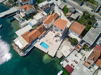 an overhead view of a house on the water at Apartments Tamaris in Tivat