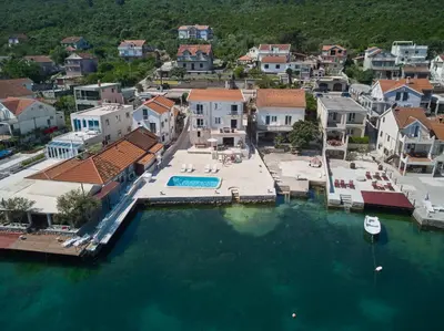 an aerial view of a town with a pool in the water at Apartments Tamaris in Tivat