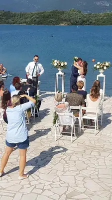 a group of people waiting for a wedding on the water at Apartments Tamaris in Tivat