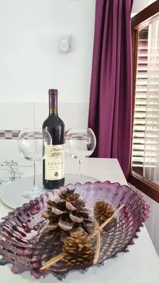 a bottle of wine and two wine glasses on a table at Apartment Jelena Sutvara in Kotor