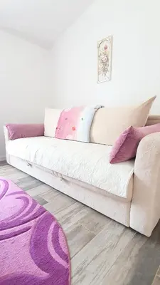 a white couch in a living room with a purple rug at Apartment Jelena Sutvara in Kotor