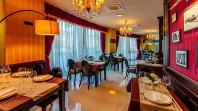a dining room with tables and chairs in a restaurant at Luxury Apartments Mia in Budva