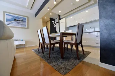 a dining room with a wooden table and chairs at Luxury Apartments Mia in Budva