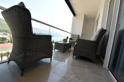 a room with two chairs and a balcony with a view at Luxury Apartments Mia in Budva