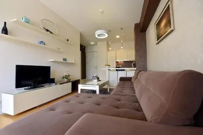 a living room with a couch and a television at Luxury Apartments Mia in Budva