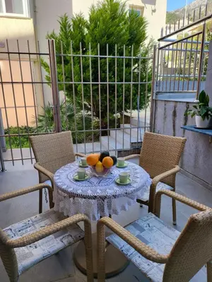 a table with a bowl of fruit on a patio at Apartment Rachel in Petrovac na Moru