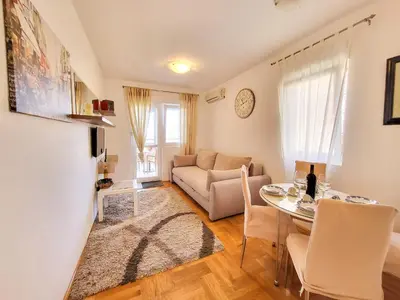 a living room with a table and a couch at Apartment Rachel in Petrovac na Moru